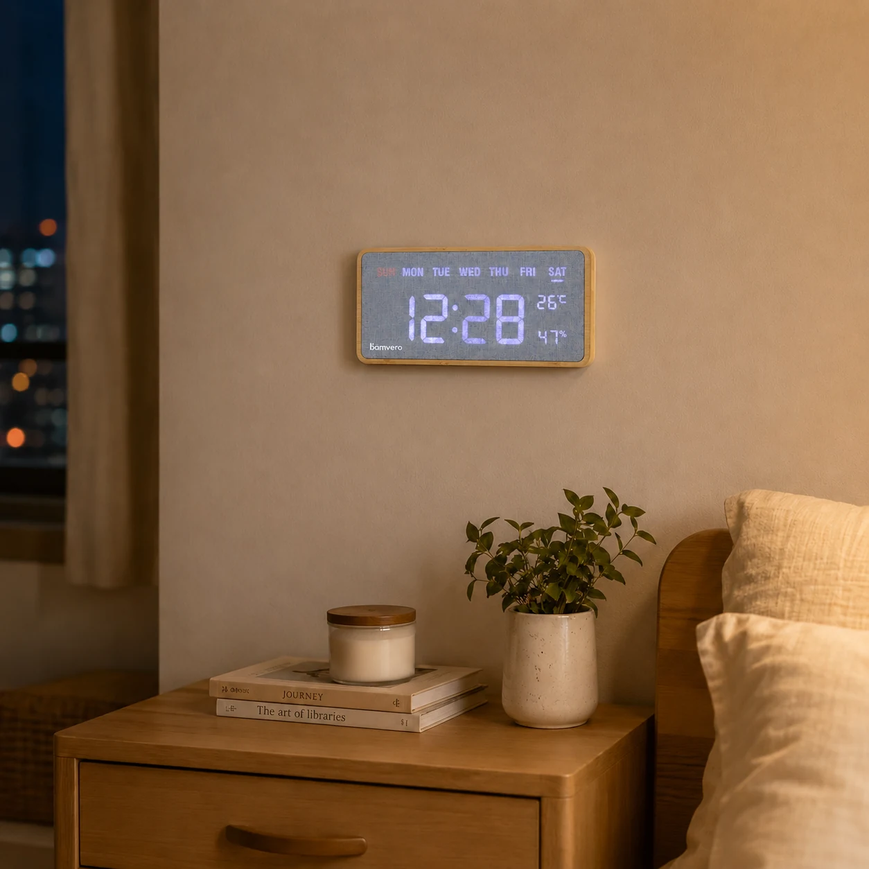 G290 bamboo digital wall clock shown above a bedside table in a warm night scene