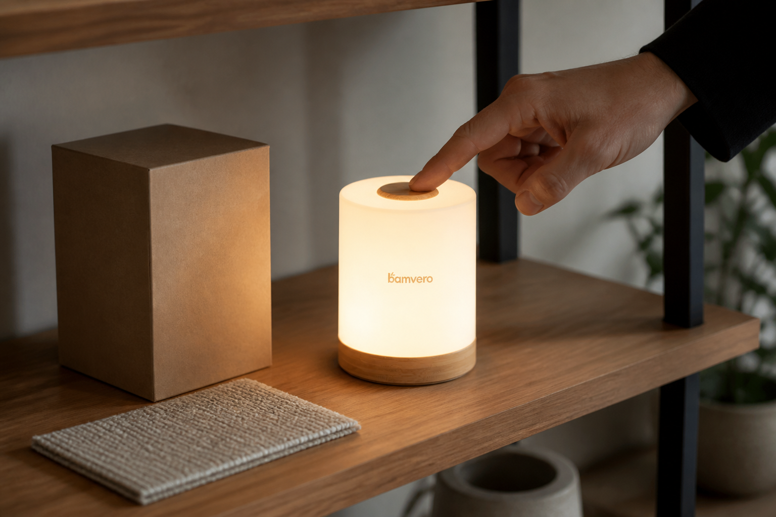 Distributor buyer touching the top control of a glowing T2633 bamboo table lamp on a sample-room shelf